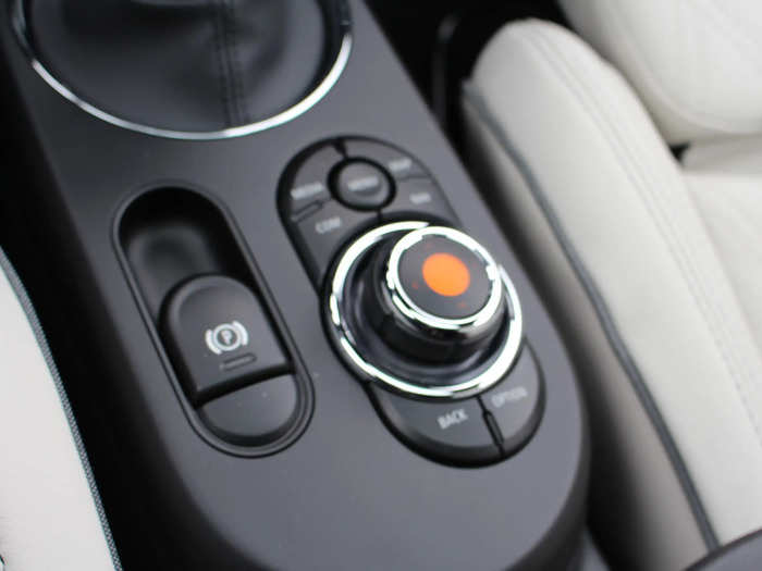 It can be operated using this knob-and-buttons interface on the console between the front seats.