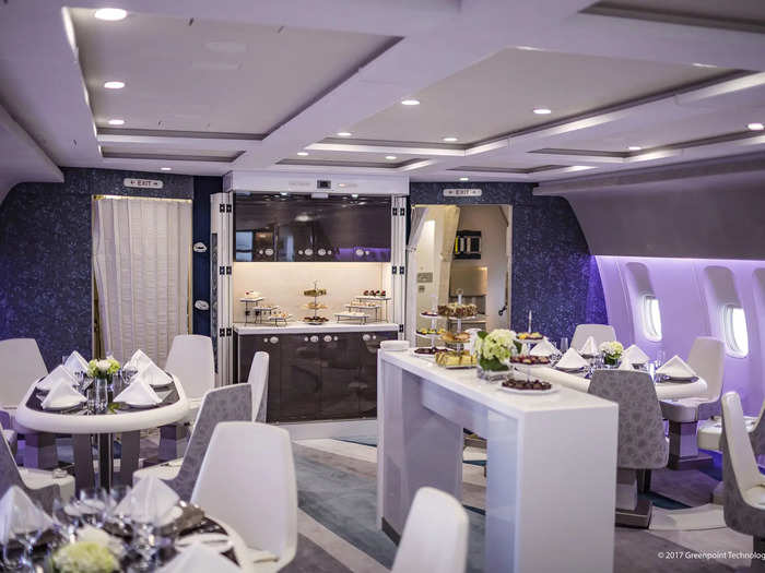 Ahead of the passenger cabin is the social lounge complete with tables, counters, and couches.