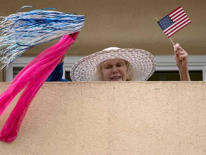 Dancing, cheering, and singing can be heard and seen from balconies across California, US.