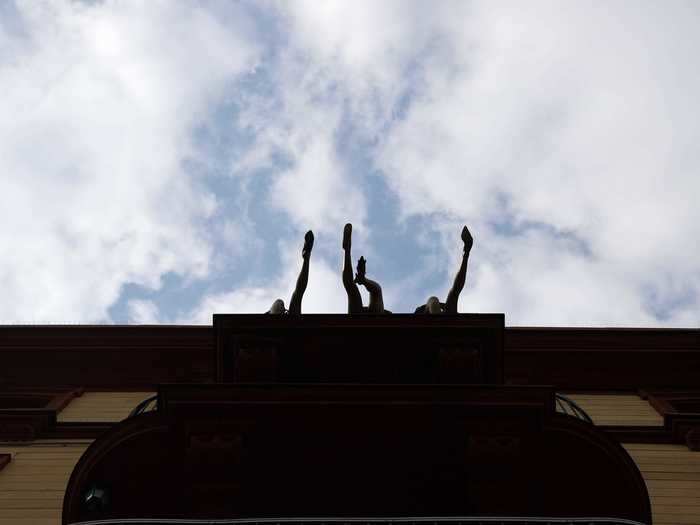 People swing their legs outside of a balcony in Frankfurt, Germany.