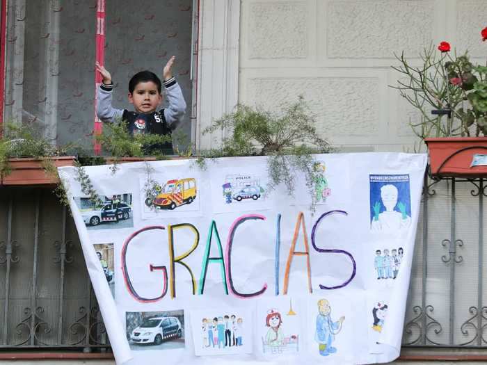 A little boy in Barcelona, Spain, cheers from his family