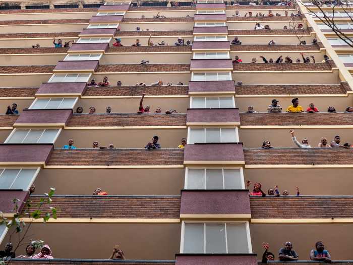 During the 21-day lockdown in Johannesburg, South Africa, residents wave and cheer to each other.