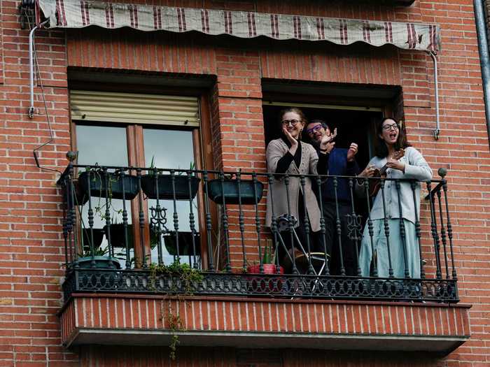 A family in Madrid, Spain, cheers, claps, and plays the ukulele to celebrate medical workers.