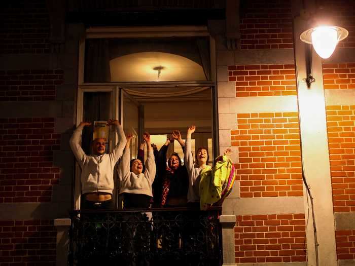 A family squeezes onto their balcony in Brussels, Belgium.