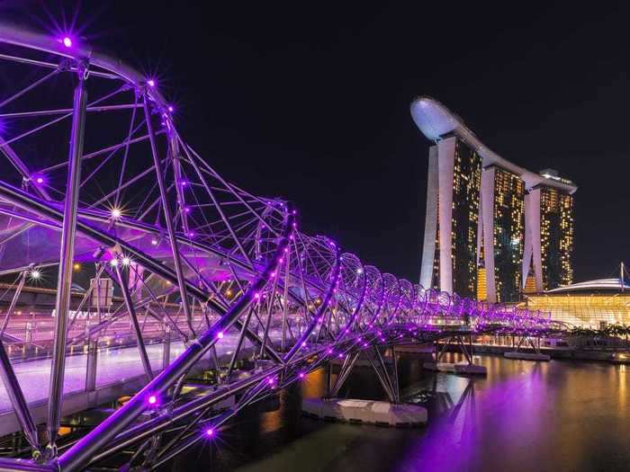 The twisty Helix Bridge in Singapore lights up at night, with each color representing different DNA strands.