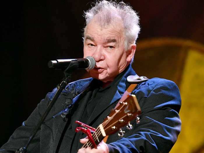 John Prine has been hospitalized after experiencing a "sudden onset of Covid-19 symptoms."