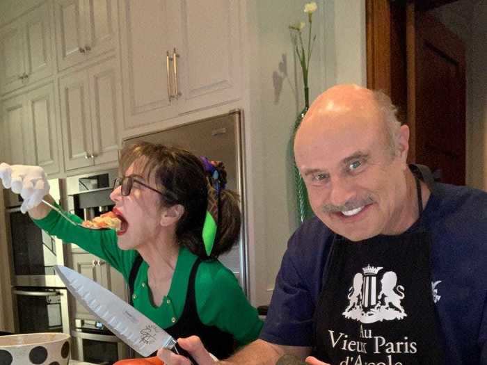 Dr. Phil cooked with his wife in his home kitchen.