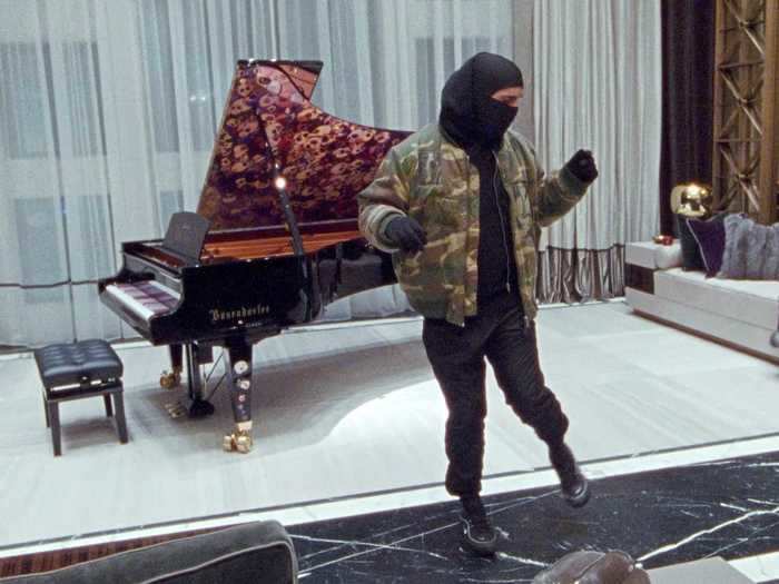 He also stood in front of his grand piano, revealing the gorgeous details around the apartment.