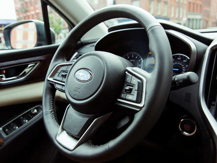 In front of the driver is a nicely contoured leather-wrapped steering wheel complete with paddle shifters. Beyond that is a set of traditional analog gauges flanking a digital information display.