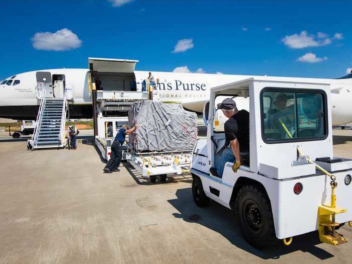 The jet flies both cargo and passengers, known as a combi aircraft with freight being loaded in the front...