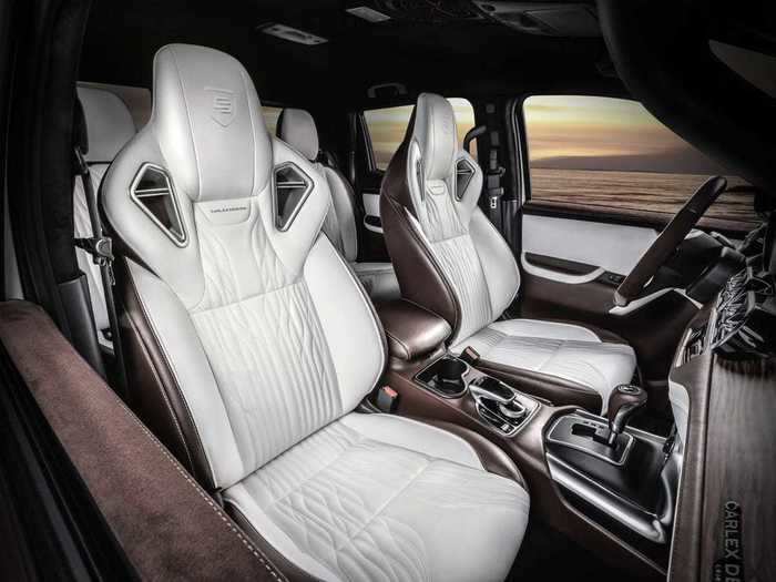 The interior features plenty of leather and faux-suede covering the seats, gear shifter, center armrest, and door panels.