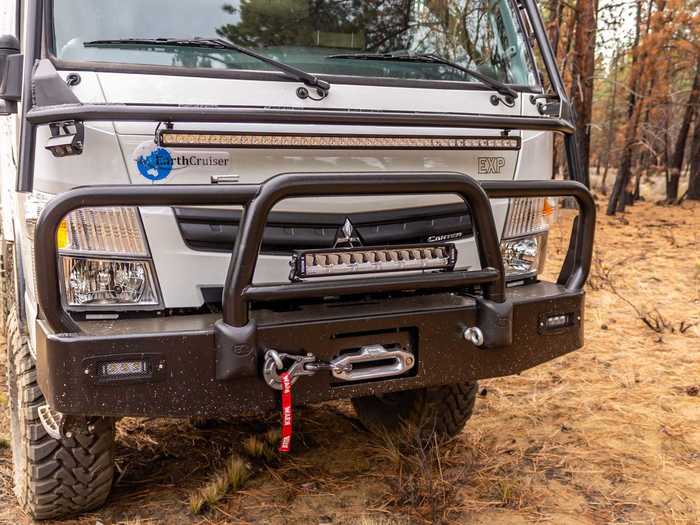 There is a front bull bar that protects the vehicle in case of a collision, as well as skid plates that shield certain parts of the underbelly that hold "critical components".