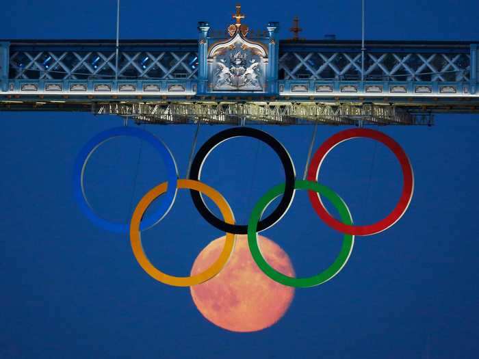 In a photo worthy of a gold medal, the full moon rose through the Olympic Rings hanging beneath Tower Bridge during the London 2012 Olympics.