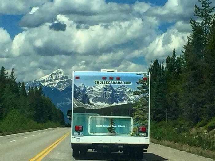 The advertisement on the back of this truck lines up almost perfectly with its real-life surroundings.