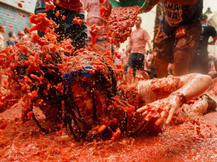 In Spain, revelers are covered from head to toe in tomatoes at La Tomatina festival.