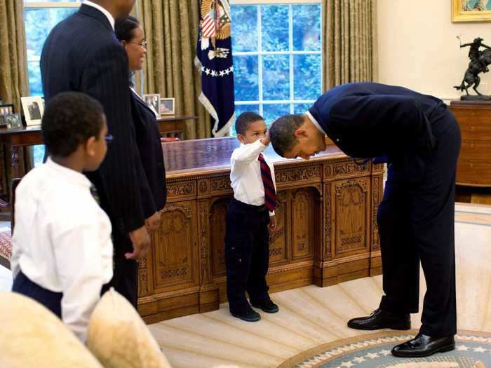 Former White House photographer and author of "Obama: An Intimate Portrait" Pete Souza captured this iconic shot of a young African American boy seeing himself in the first black president.