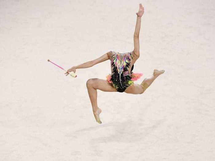 Rhythmic gymnast Izzah Amzan of Malaysia also appears momentarily headless in this photo by William West.