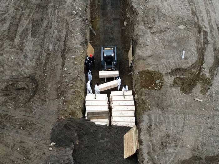 Burials on Hart Island have historically been carried out by city detainees, but are now being done by contracted workers to comply with social distancing rules.