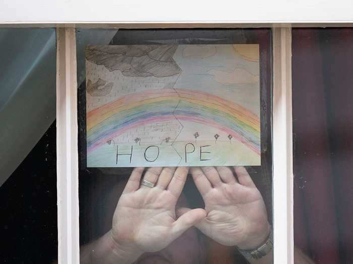 And others have put up signs of encouragement in their windows. This drawing by a young boy in England shows the message "hope," written beneath a rainbow.