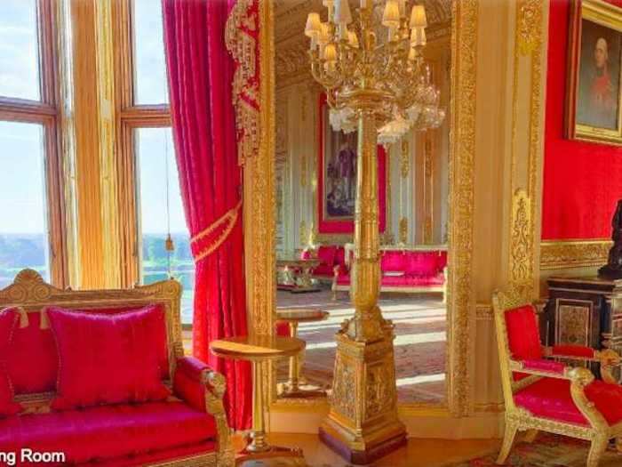 The drawing room appeals to visitors with its striking red decor and its stunning view of the nearby Berkshire countryside.