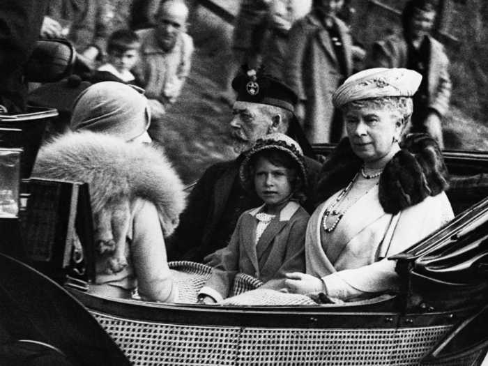 1933: This photo shows the princess enjoying a carriage ride with her grandparents, King George V and Queen Mary of England.