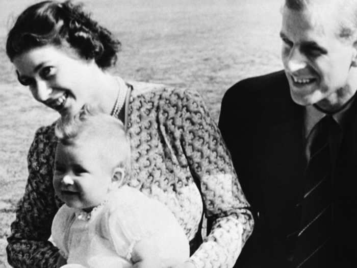 1949: An eight-month-old Prince Charles is cradled by his mother on a warm July day at Windlesham Moor, their summer residence, in Ascot, England.