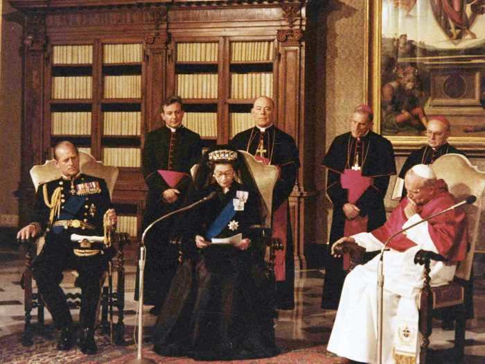 1980: It was in 1980 that the Queen visited the Vatican for the first time. Here, she talks to Pope John Paul II while her husband looks on.