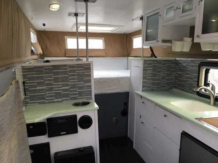 The pop-top adds several windows and two feet of headroom to the inside of the camper.