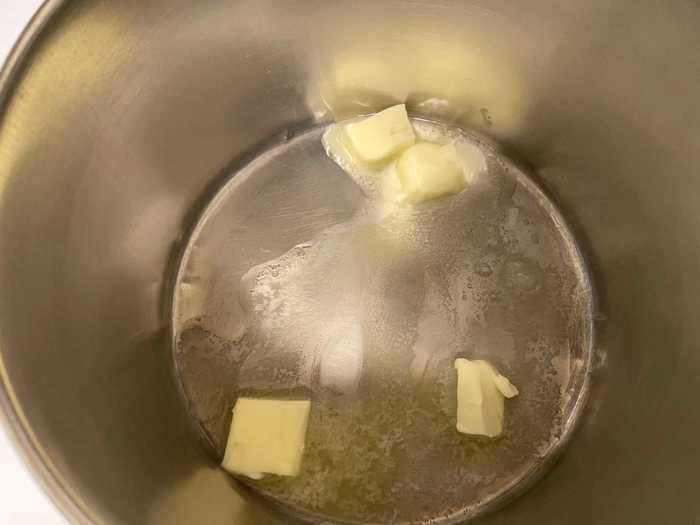 I first chopped three tablespoons of butter into small squares, and melted them in a saucepan over low heat.