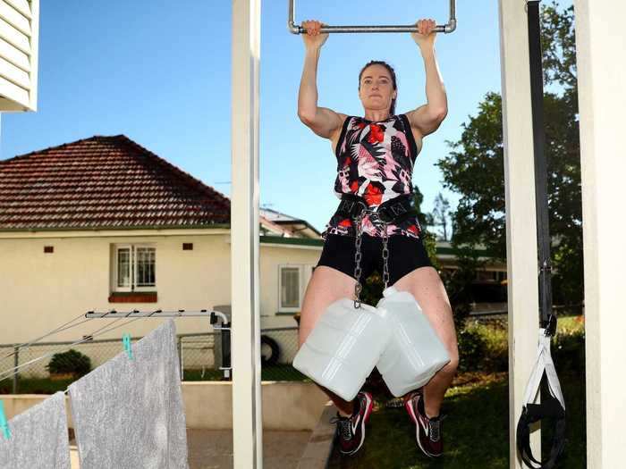 In Brisbane, Olympic swimmer Cate Campbell trained outside her home. She did pull-ups while weighed down with some reasonably heavy-looking bottles on April 16.