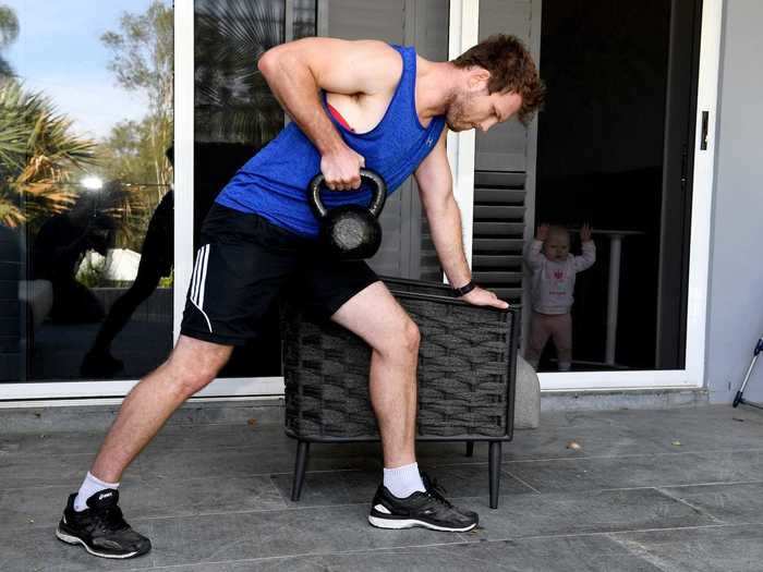 Elsewhere in Brisbane, Australian boxer Jeff Horn trained outside his home, while a child watched from inside on April 20.