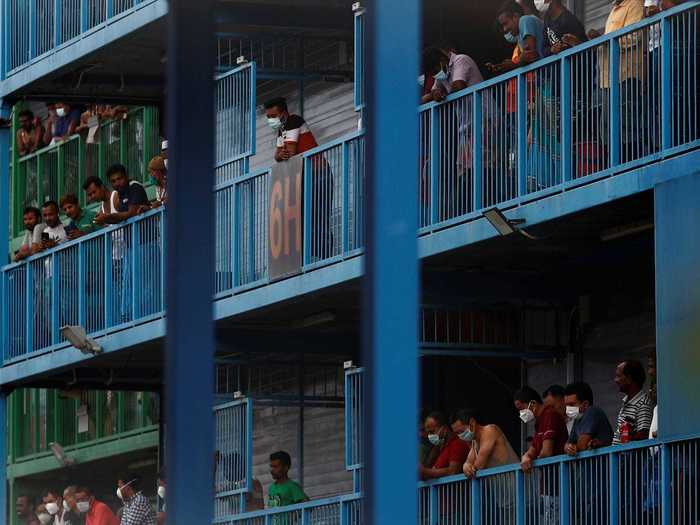 One of the worst-affected dorms is a massive complex called S11 Punggol. The facility houses more than 300,000 migrant workers from Bangladesh and India, who live in cramped rooms with bunks for up to 20 men.