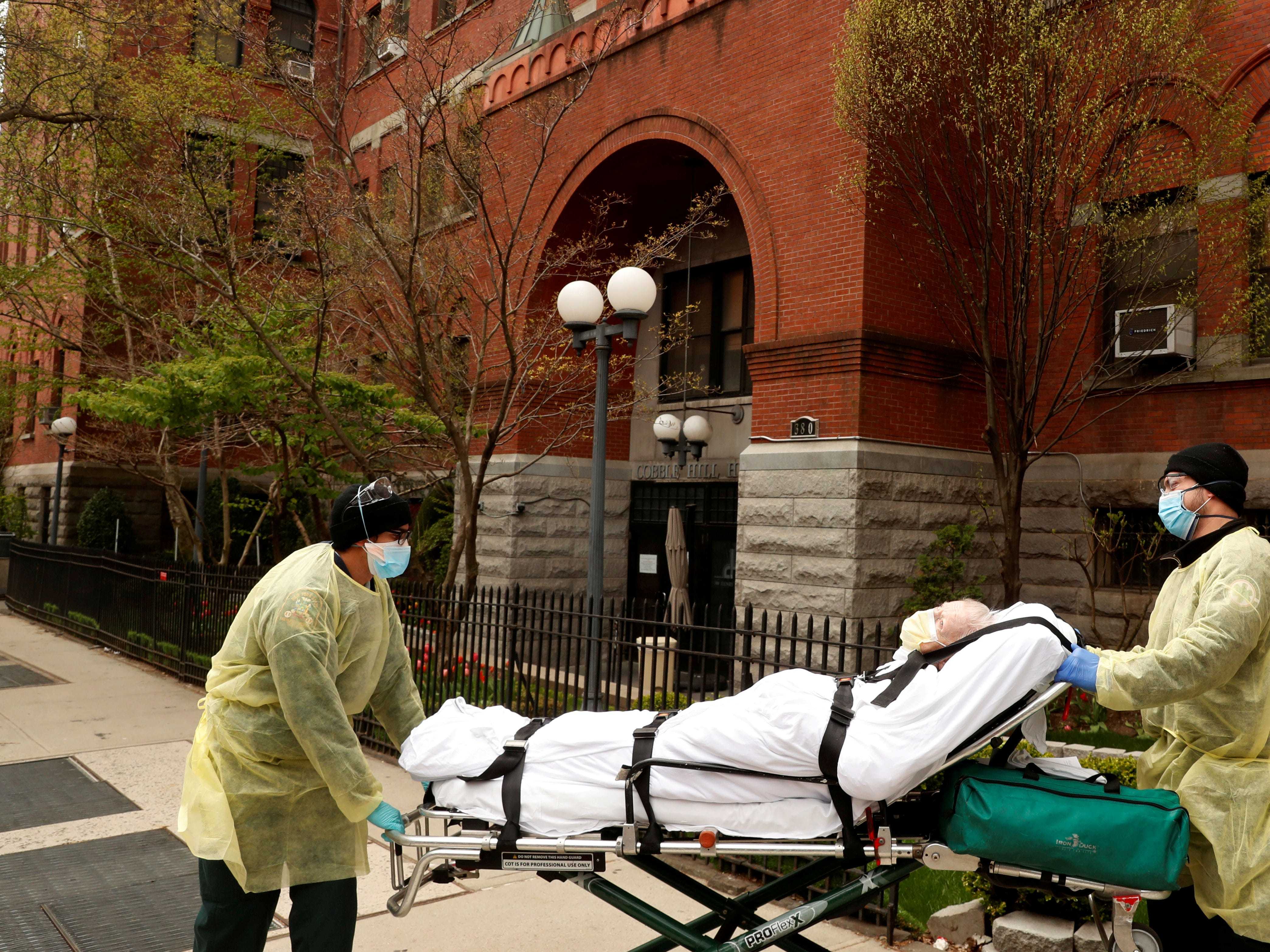 FILE PHOTO: Emergency Medical Technicians (EMTs) wheel a man out of the Cobble Hill Health Center nursing home during an ongoing outbreak of the coronavirus disease (COVID-19) in the Brooklyn borough of New York, U.S., April 17, 2020. REUTERS/Lucas Jackson