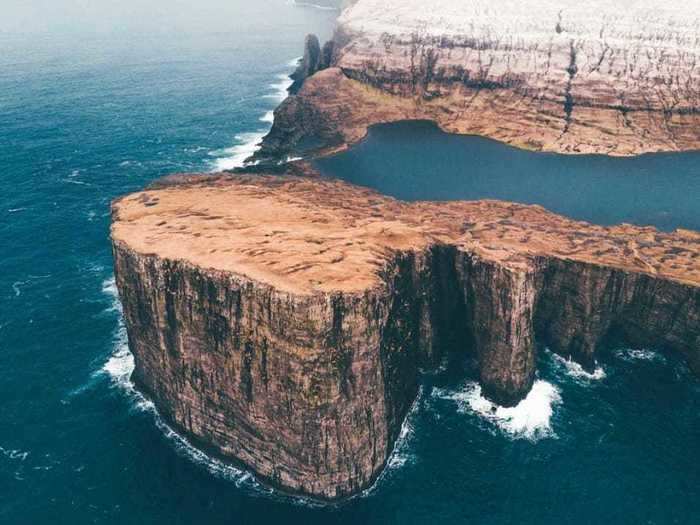 Some coastlines seem surreal, like this one on the Faroe Islands, which has a lake sitting atop a cliff.