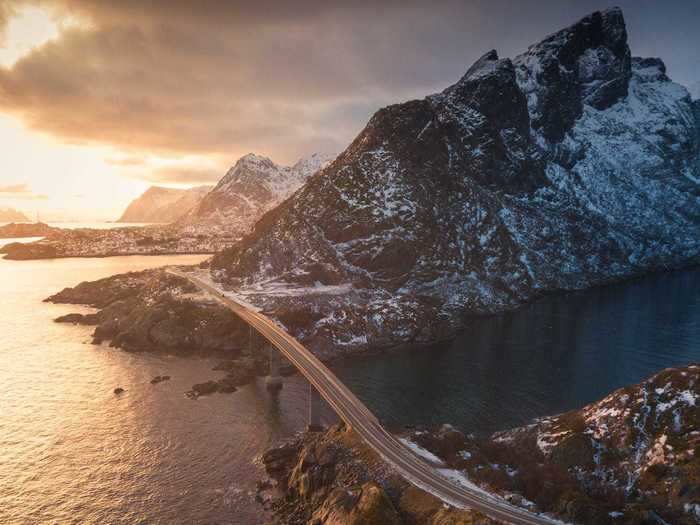 This scenic bridge in Norway stretches over the Djupfjorden, offering views of the snowy mountain tops nearby.