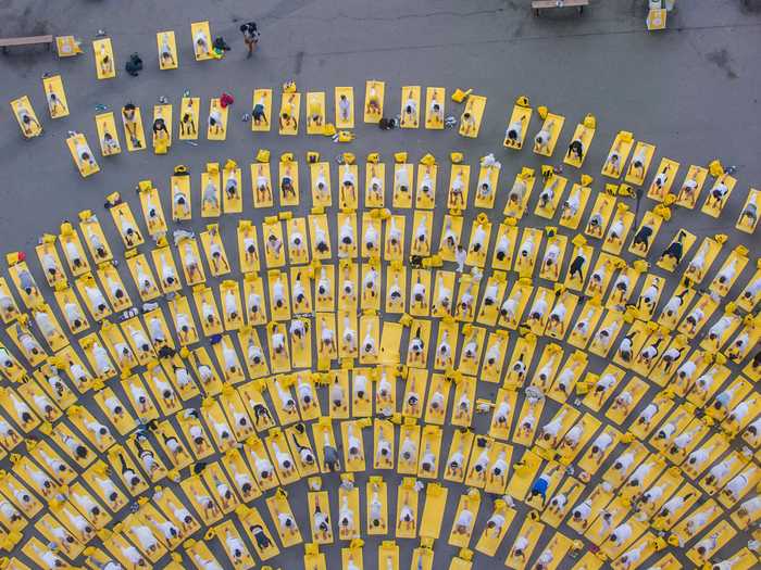 This beautiful aerial shot captures a group of people participating in International Yoga Day.