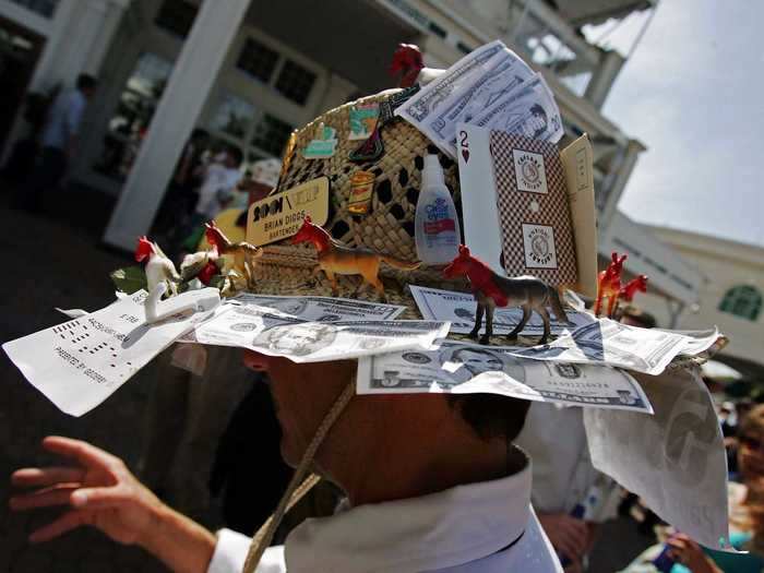 Fake money, horse figurines, and other knickknacks were piled onto a 2006 hat that appears to be the result of some serious DIY skills.