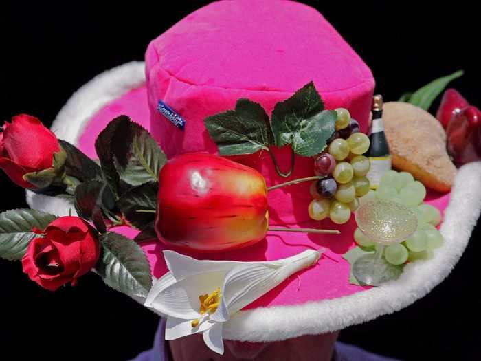 Fruit, wine, and rose details enhance this neon pink felt top hat from the 2006 event.