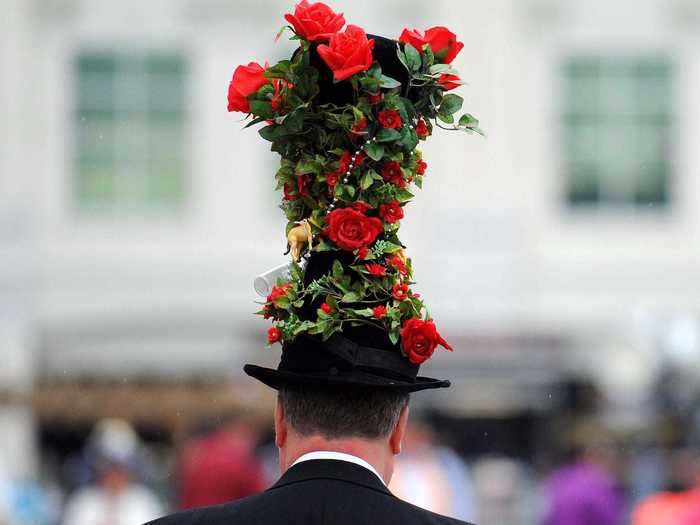 Embedded within this leafy green top hat from 2013 was an abundance of red roses and miniature horse figurines.