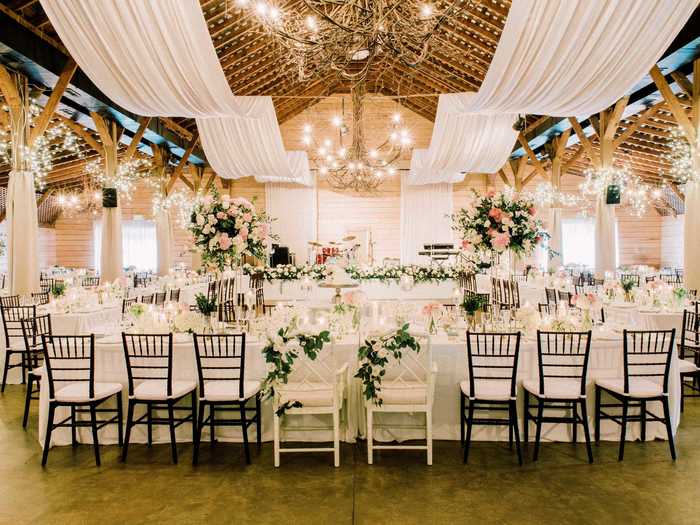 Cloth draping can be added to the ceilings of some barn wedding venues to give a more elegant, ethereal look.