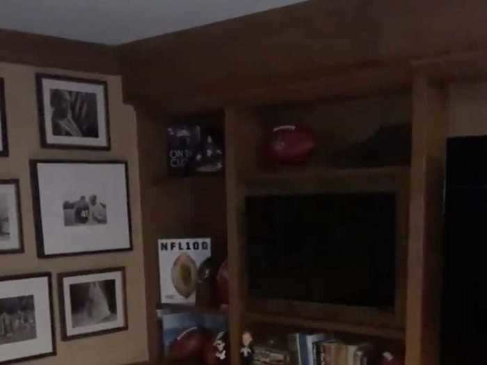 His shelves and walls are covered with books and memorabilia in addition to TVs.