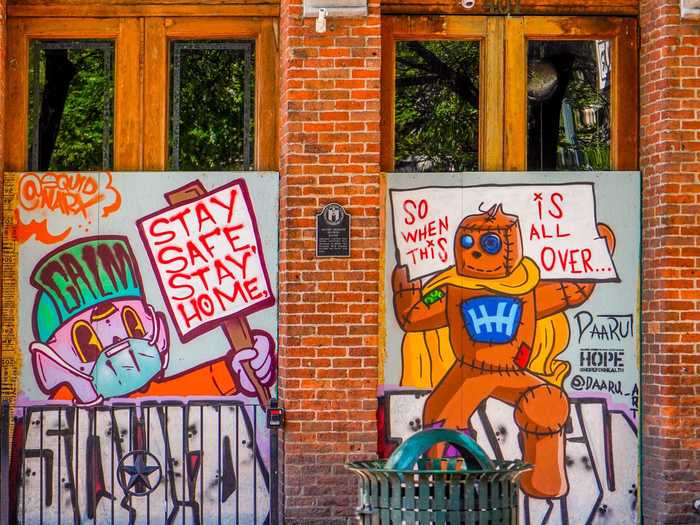 A lot of the murals have the same message — stay home now so we can party later.