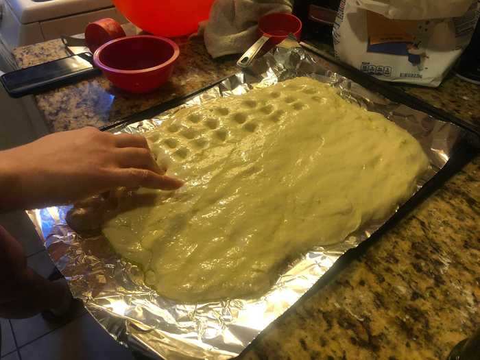 Next, we had to use our fingertips to create dimples so that the brine could easily seep into the dough.