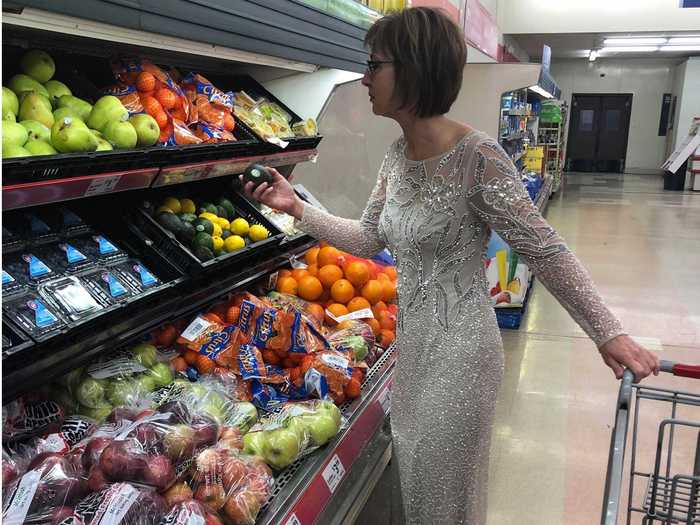 Emge posed at a gas station, grocery store, and even pretended to fish in the gown.