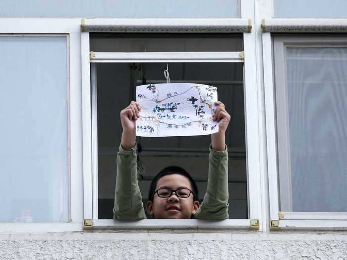 In Beijing, China, 11-year-old Li Congchen proudly held up his drawing that depicts the coronavirus arriving on a "bat aircraft", being defeated by "vaccine guns," and humans risking their lives to fight it.