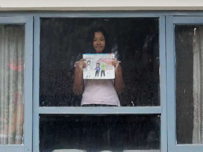 In Nepal, 11-year old Kyra Bajracharya drew an image of a healthcare worker wearing a mask outside of a hospital next to two adults.