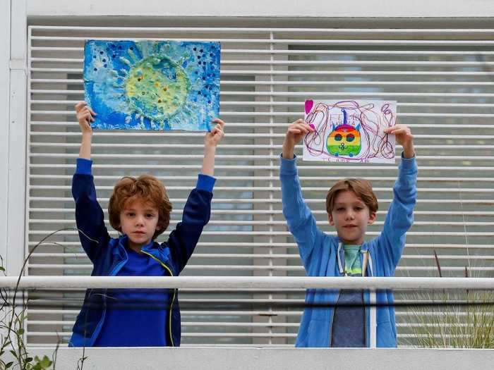 And in Argentina, Juan and Mateo posed outside with their drawings, one of which depicts a brightly colored cat with the words "Te amo," meaning "I love you" written below.