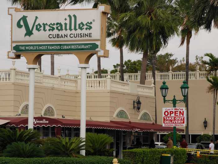 The takeaway window has always been a key feature at Versailles. Now, people wait in a socially distanced line for their favorite classic Cuban food.