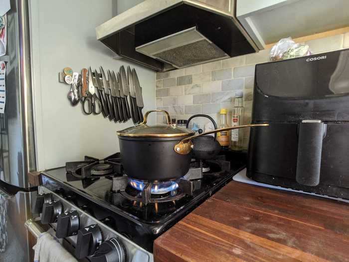 By the stove, they keep knives on a magnetic wall strip and spices on the back ledge of the stove top. This keeps the other half of the counter that