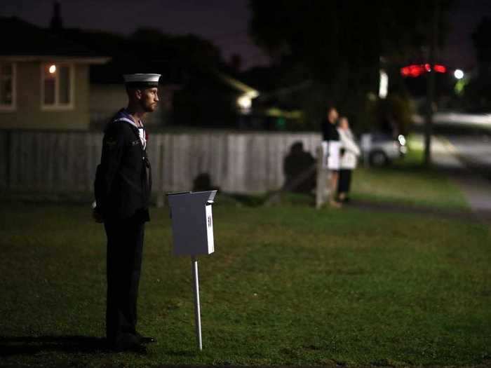 Here, a marine stands outside his mailbox in Auckland, New Zealand.